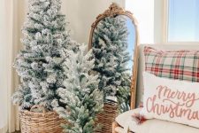 a duo of flocked Christmas trees in baskets is a cool decoration for the holidays and will cozy up any space