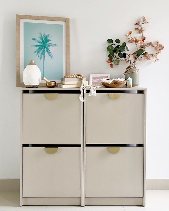 a greige IKEA Bissa hack with gold pulls is a cool idea for a Scandinavian or modern interior