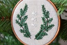 a rustic Christmas ornament of an embroidery hoop, embroidered branches and letters is a cool decoration