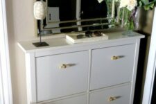 a white Hemnes shoe storage piece with new handles gets a fresh look and a new feel