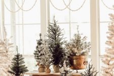 a whole arrangement of Christmas trees in baskets and buckets is a lovely idea for a farmhouse space