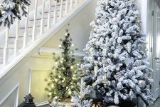 multiple Christmas trees, flocked ones and usual, with lights and in baskets are great for farmhouse home decor
