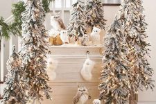 multiple flocked Christmas trees, faux owls and sotckings are amazing for farmhouse Christmas decor