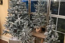multiple flocked Christmas trees in planters are great to style any space and give it a modern farmhouse feel