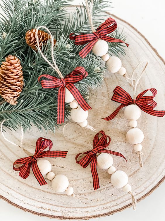 pretty and easy to make rustic Christmas ornaments of wooden beads and red plaid bows are great for styling a tree