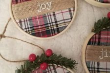 pretty rustic Christmas ornaments of embroidery hoops, plaid fabric, berries and evergreens and twine