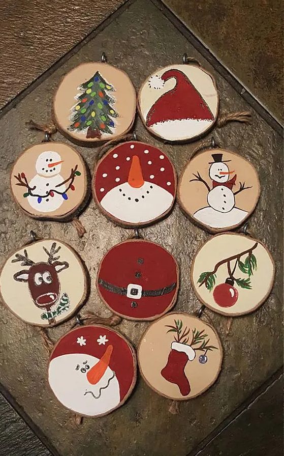 various painted wood slice ornaments that include snowmen, stockings, deer and trees