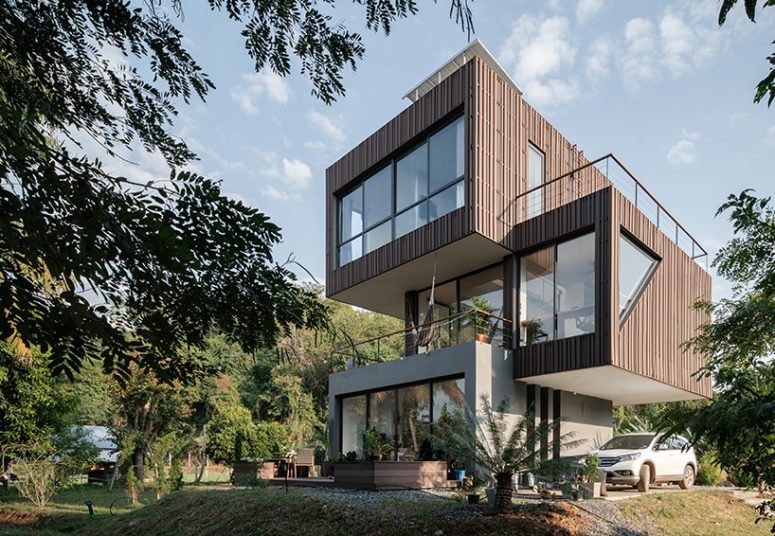 This contemporary home in rural Thailand is composed of three sculptural volumes that are stacked on each other