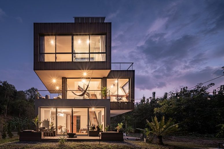 The house features glass walls and large terraces strategically placed here and there
