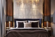 02 a luxurious bedroom with a stunning chandelier, cool lamps and gorgeous bedding plus a statement headboard