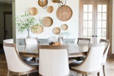 02 a vintage farmhouse dining room done in neutrals and with a large wooden round table