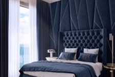 03 navy velvet and a statement headboard wall make the space wow, and gold touches add to this luxury