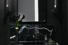 05 a chic moody bathroom in black and graphite grey with a marble wall-mounted sink