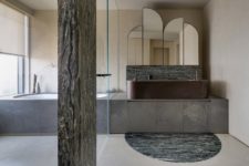 06 The bathroom features truly wabi-sabi, with wooden and marble pillars a stone clad tub and timber