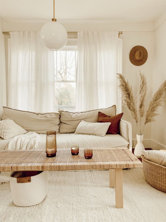 a super neutral boho space with white woven carpet flooring for a texture and to make the space bigger
