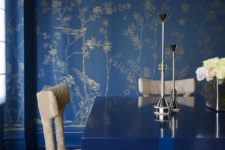07 a bright blue living room with botanical printed wallpaper, a modern table and wrapped chairs