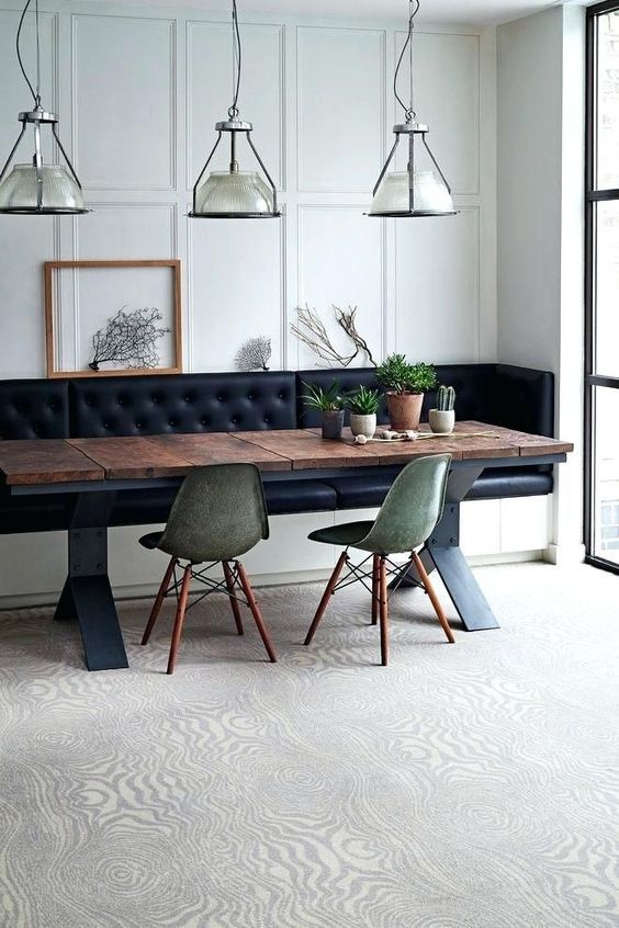 A dining space with a built in leather bench with storage, which is a gorgeous and smart solution