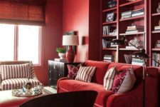 09 a monochromatic bold red living room with built-in shelves, comfy furniture and some dark touches for drama