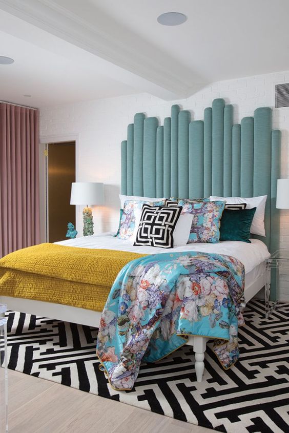 a statement light blue upholstered headboard made of planks is a stylish idea for a bright bedroom