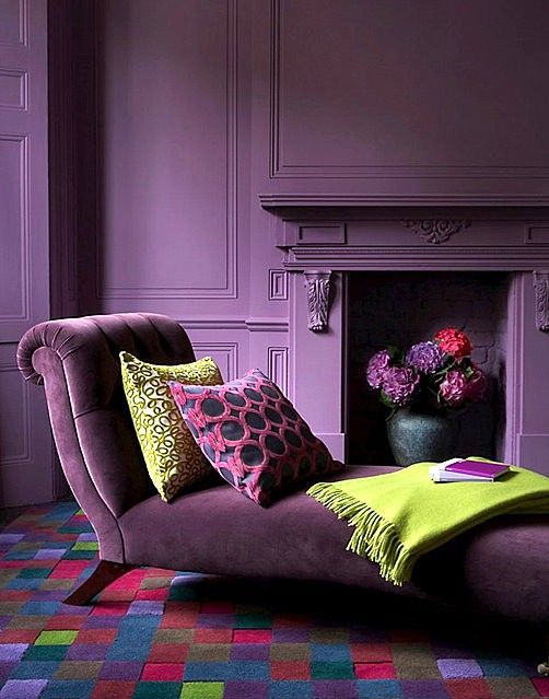 a very refined deep purple living room with matte walls and an exquisite velvet daybed with pillows
