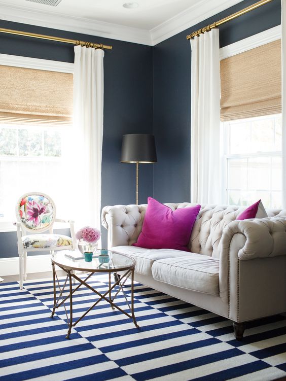 white floor-length curtains will make the space look bolder and larger, they contrast black walls
