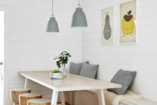 11 a chic dining space with a storage bench, a stylish wooden table and little round stools