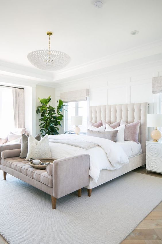 a neutral bed with a large tufted headboard is right what you need to make your bedroom cooler and more refined