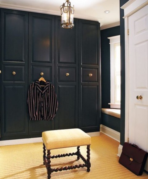 an IKEA Pax wardrobe in black with gilded knobs looks very chic and art deco