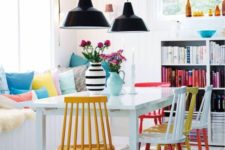 12 a neutral dining space is spruced up with colorful printed pillows and bright chairs that make a statement