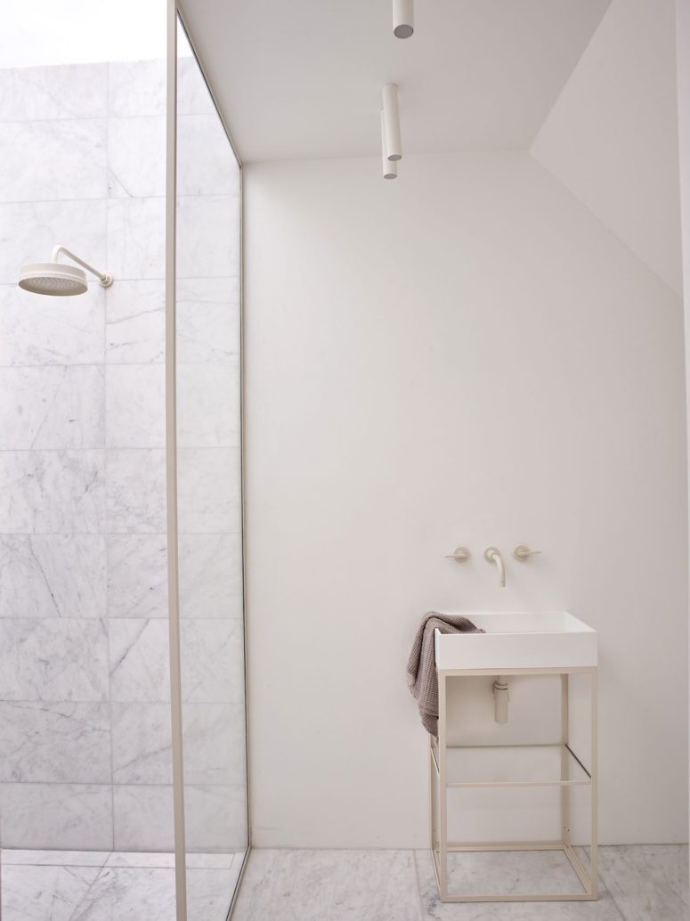 The bathrooms are done in neutrals, with marble and matte walls
