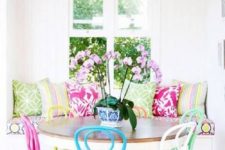 13 a bright dining space with super bright pillows and colorful chairs looks fun, cheerful and colorful