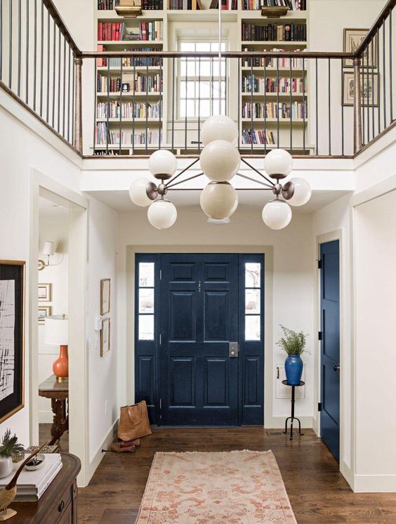 a navy door stands out in a neutral space is a cool idea to make a statement with the trendiest color of the year