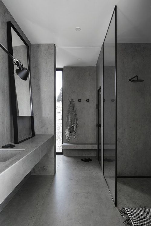 a concrete bathroom done with only concrete. tiles and glass plus touches of black