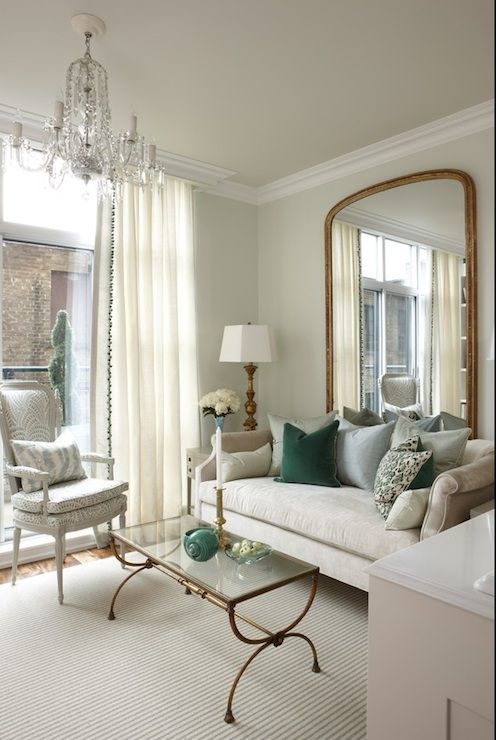 light-colored floor-length curtains match the living room and make it look higher and larger