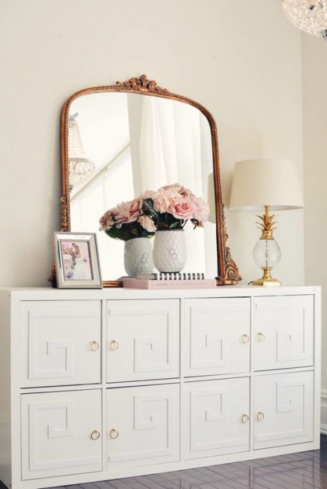 an IKEA Malm dresser turned into a chic vintage piece with overlays and brass knobs