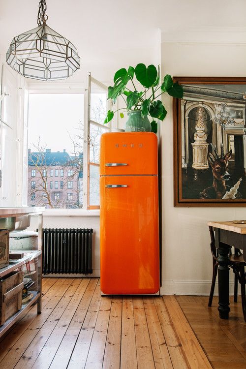 try a bright orange fridge to bring a fun and colorful touch to your kitchen and renovate it at once