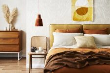 17 a fall-colored earthy bedroom in ocher, yellow, mustard and rust shades and with wood and rattan