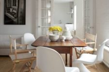 19 a chic dining room with a wooden table and totally mismatching chairs in the same color scheme