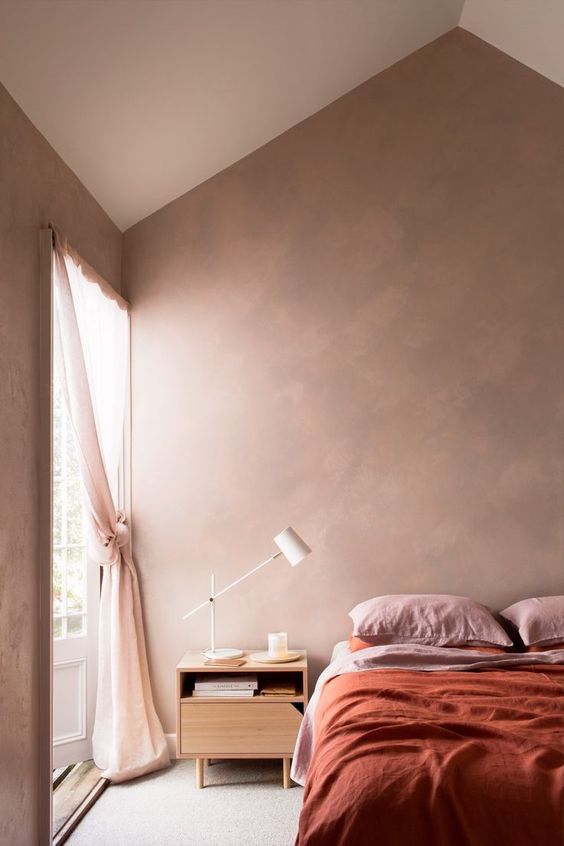 a welcoming and airy earthy tone bedroom with touches of pink and light pink for a fresh look