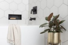 21 a neutral bathroom done with large scale hexagon tiles covering the walls for an ultra-modern feel