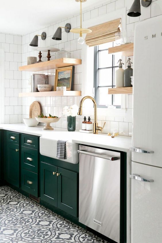 a forest green and white kitchen spruced up with gold touches and thick open shelving and Roman shades