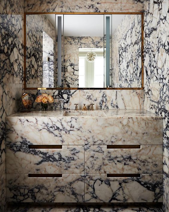 such unique marble on the walls and on the vanity will make your bathroom stand out a lot