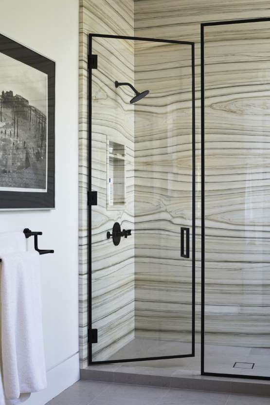a shower space done with unique marble in greys and greens with stripes looks really wow