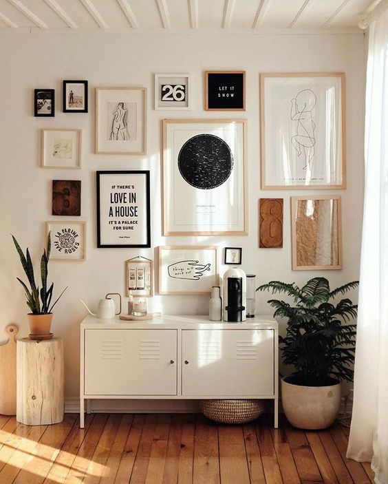 a stunning boho gallery wall with mismatching frames and various signs and works of art