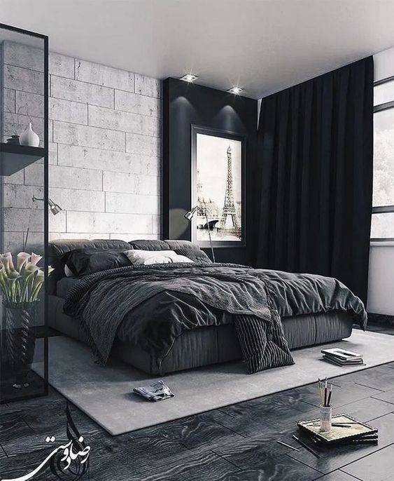 a bold black and white bedroom with dark floors, black curtains and a glass storage unit