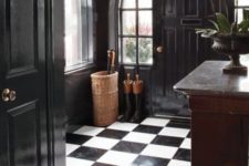 26 a refined and chic black and white entryway with a checked floor and black doors looks really wow
