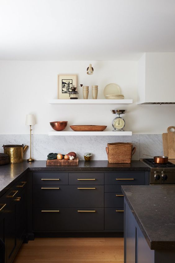 dark blue cabinets paired with black stone countertops and gold touches for a super chic look