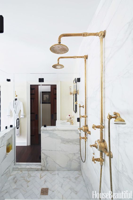 vintage brass fixtures stand out in a neutral bathroom and make it much more refined and chic