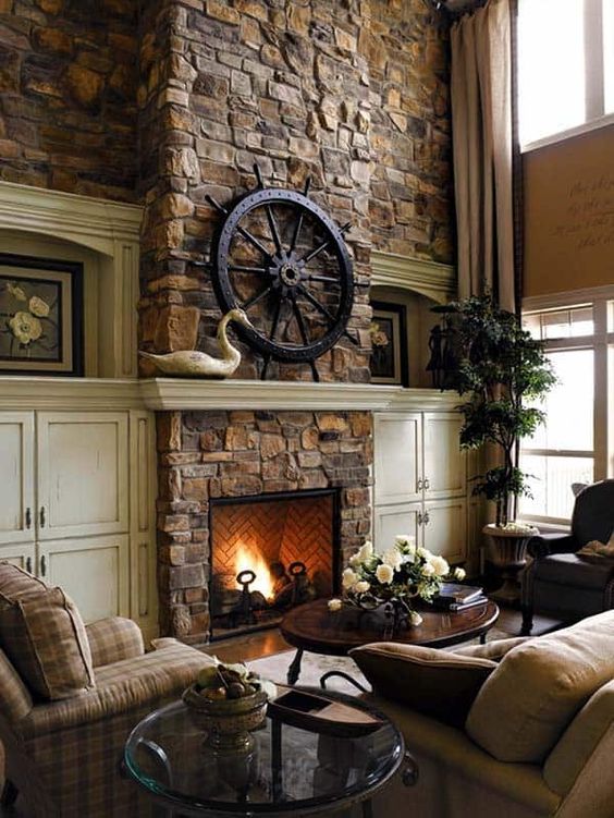 a dark vintage living room with a stone fireplace, checked furniture, potted plants and some elegant accessories