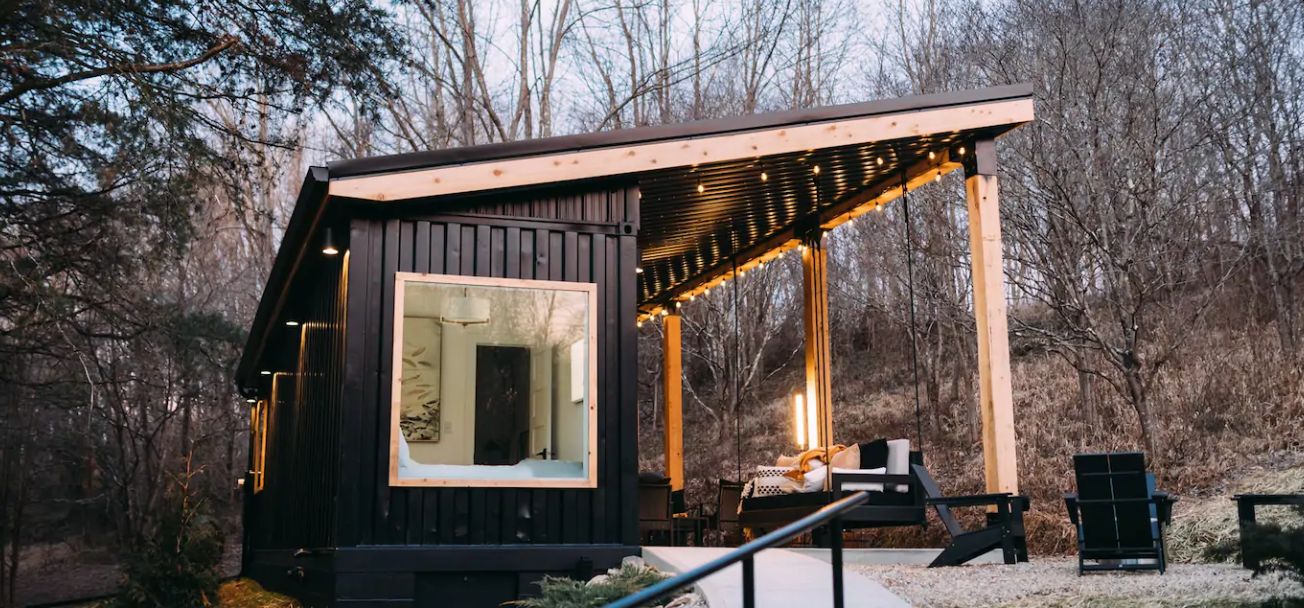 This contemporary cabin is built of a shipping container and indoor and outdoor areas are placed under the same roof